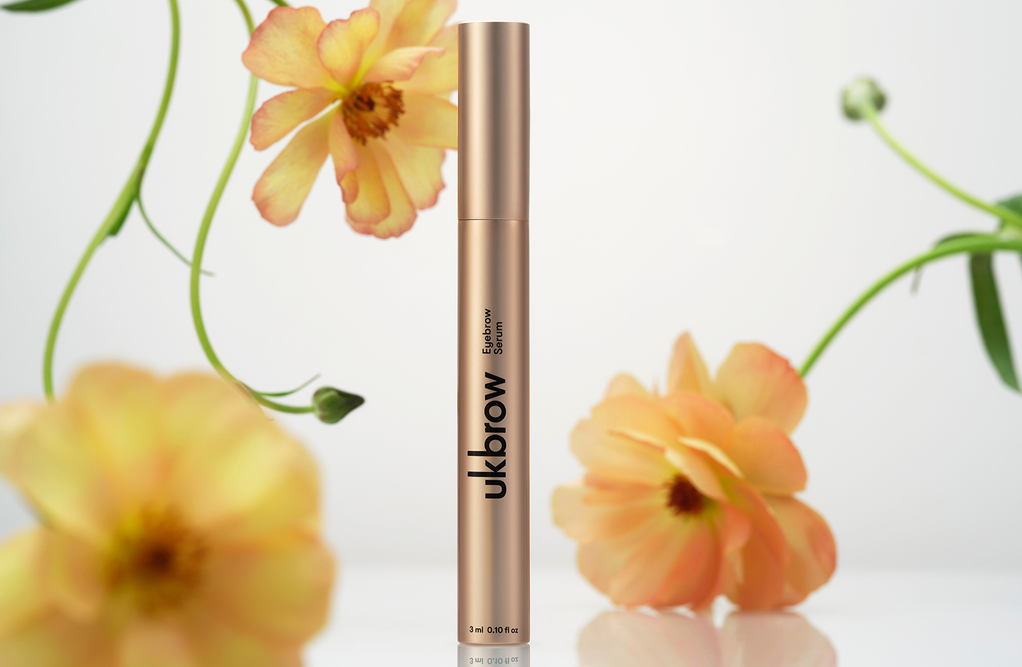 UKBROW serum with flowers in the background