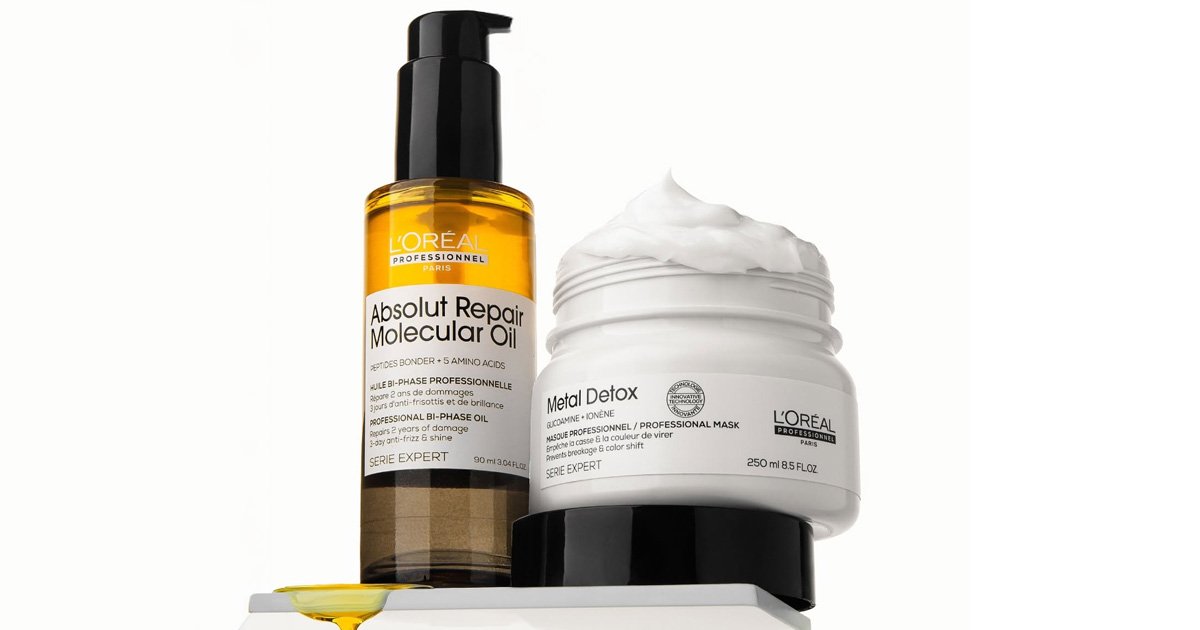 L'Oréal Professionnel Absolut Repair Molecular Oil bottle next to an open jar of Metal Detox hair mask with cream overflowing on top.