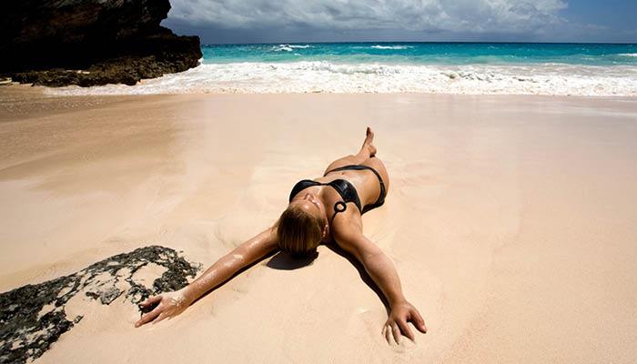girl lying on sandy beach
